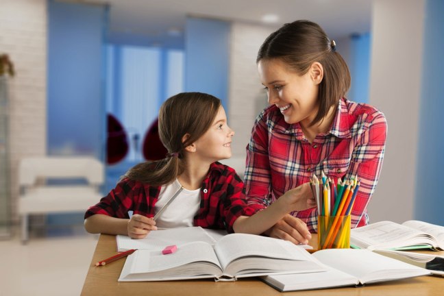 Mother and daughter homeschooling math