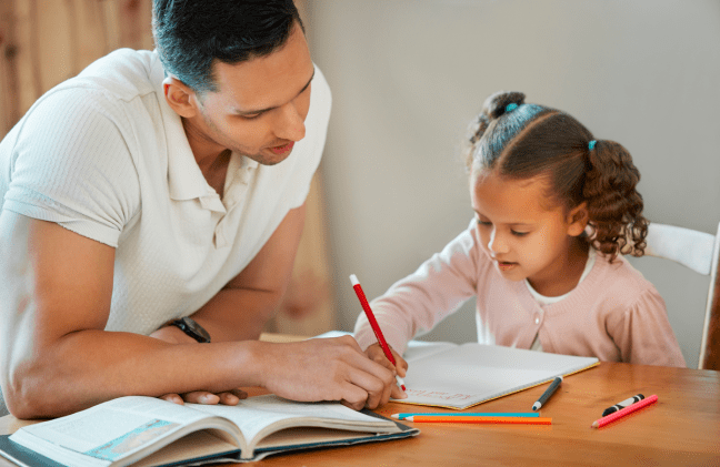 Father helping girl with math homework