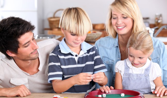 photo of family playing a dice game