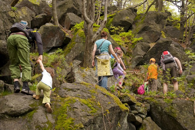photo of family hiking a rocky trail