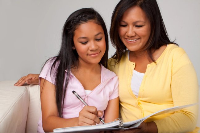 mother and teen daughter do homework together